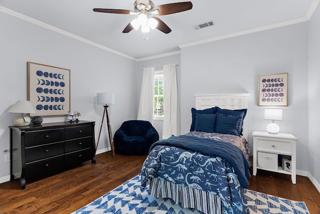 bedroom featuring crown molding, a ceiling fan, visible vents, baseboards, and wood finished floors