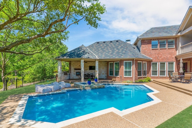view of pool featuring fence, a patio area, a fireplace, and a fenced in pool