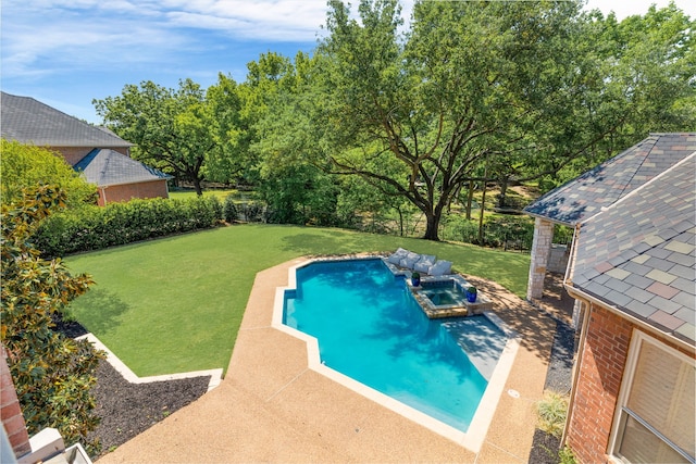 view of swimming pool featuring a patio, a yard, and a pool with connected hot tub