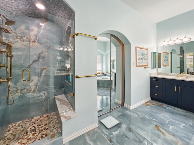 full bath with a stall shower, marble finish floor, vanity, and baseboards