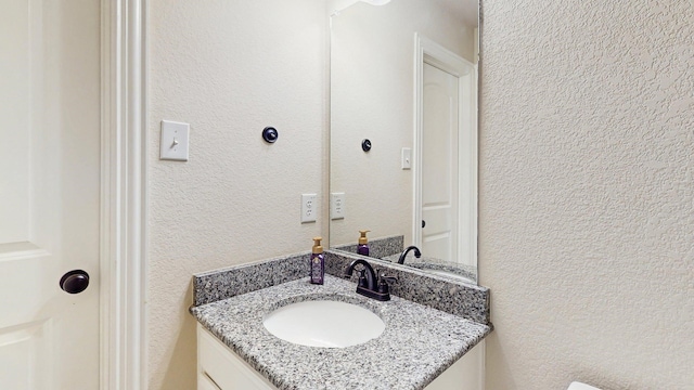 139 Townlake Dr, Prosper, TX 75078 - bathroom with vanity and a textured wall