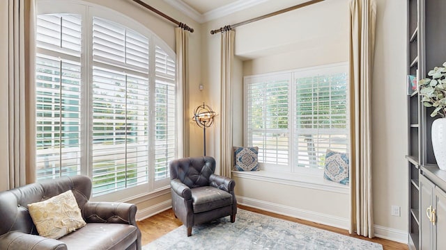 139 Townlake Dr, Prosper, TX 75078 - living area with plenty of natural light, crown molding, wood finished floors, and baseboards