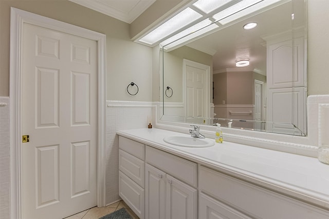 bathroom featuring ornamental molding, tile patterned floors, wainscoting, and vanity