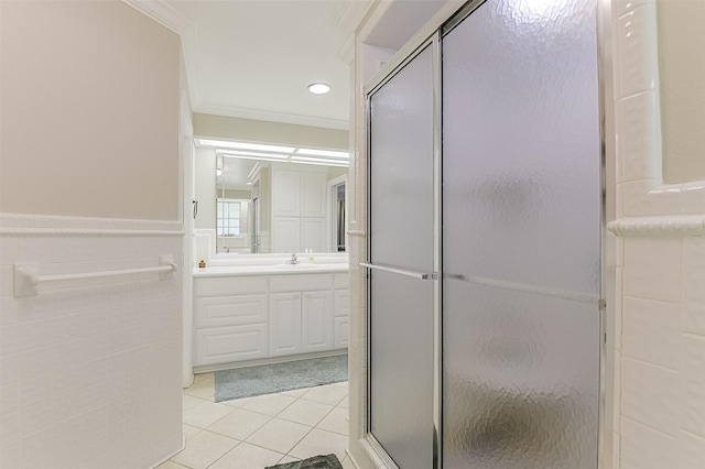 full bath with a stall shower, tile patterned flooring, crown molding, and vanity