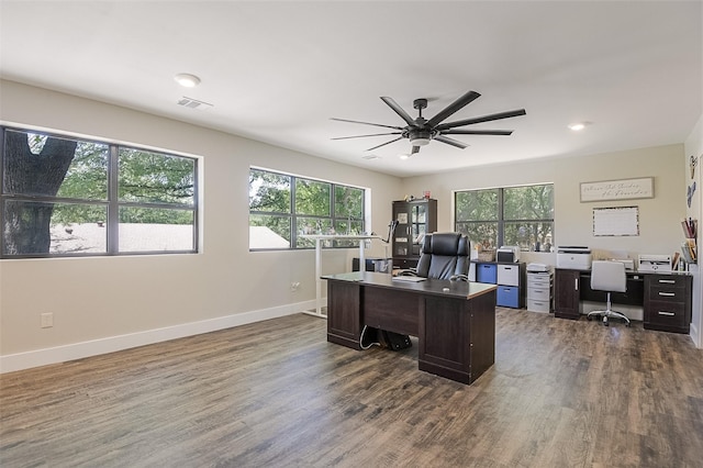office with dark wood-style flooring, visible vents, a ceiling fan, and baseboards