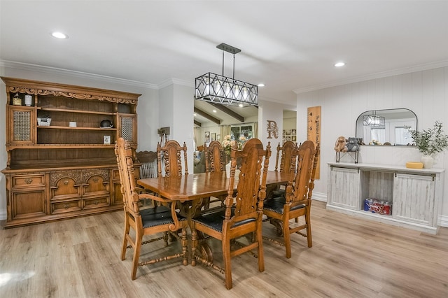 dining space featuring crown molding, light wood finished floors, and recessed lighting