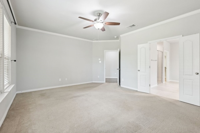 unfurnished bedroom with crown molding, visible vents, ceiling fan, baseboards, and light carpet