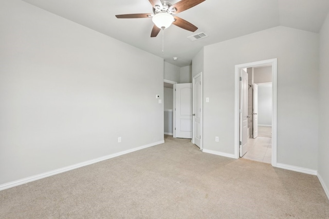 unfurnished bedroom featuring connected bathroom, visible vents, light colored carpet, and baseboards