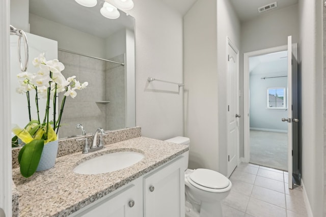 bathroom featuring visible vents, baseboards, toilet, vanity, and tile patterned flooring