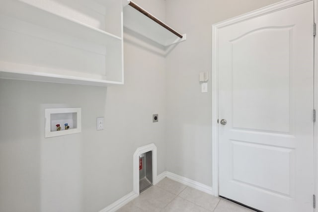 washroom featuring hookup for an electric dryer, light tile patterned floors, washer hookup, laundry area, and baseboards