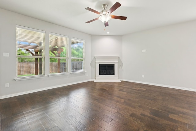 unfurnished living room featuring recessed lighting, ceiling fan, a glass covered fireplace, baseboards, and wood finished floors