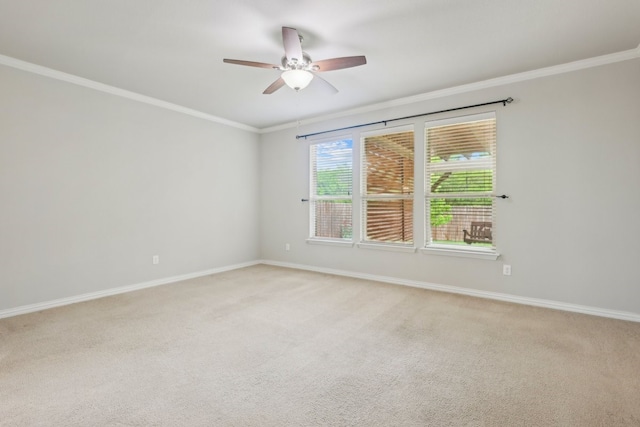 empty room featuring ceiling fan, light carpet, and crown molding