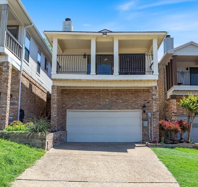 5709 Southern Cross Dr, Rockwall, TX 75032 - view of front of property featuring brick siding, a garage, a balcony, and driveway