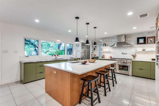 416 Crestwood Dr, Fort Worth, TX 76107 - kitchen featuring high quality appliances, visible vents, green cabinetry, and wall chimney exhaust hood