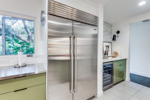 416 Crestwood Dr, Fort Worth, TX 76107 - kitchen with stainless steel counters, plenty of natural light, wine cooler, stainless steel built in fridge, and backsplash