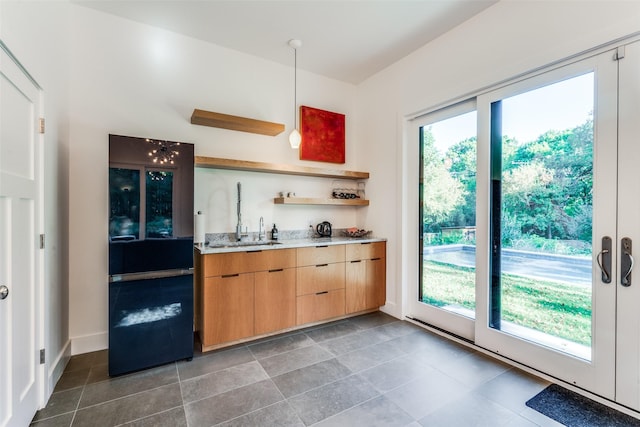 416 Crestwood Dr, Fort Worth, TX 76107 - kitchen with light stone counters, open shelves, a sink, freestanding refrigerator, and baseboards