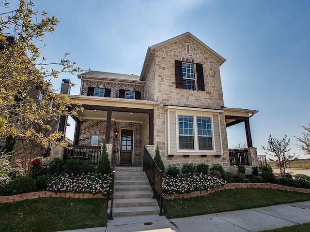 2200 Whitman Ln, Carrollton, TX 75010 - view of front of property with covered porch, stone siding, and brick siding