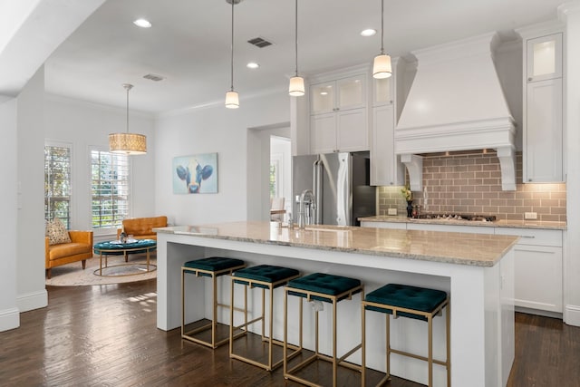 2200 Whitman Ln, Carrollton, TX 75010 - kitchen featuring stainless steel refrigerator with ice dispenser, wall chimney exhaust hood, backsplash, gas cooktop, and crown molding