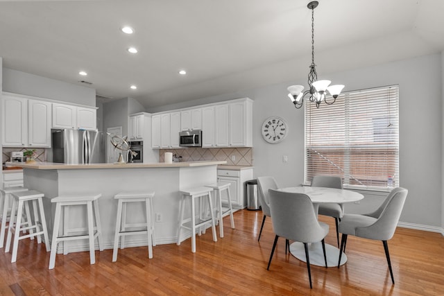 2209 Graystone Ct, Keller, TX 76248 - dining space with a chandelier, light wood finished floors, recessed lighting, and baseboards