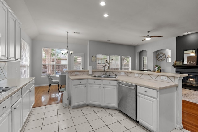 2209 Graystone Ct, Keller, TX 76248 - kitchen with dishwasher, light countertops, a sink, arched walkways, and white cabinets