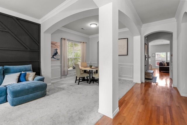 2209 Graystone Ct, Keller, TX 76248 - living area with arched walkways, crown molding, light wood finished floors, and a decorative wall
