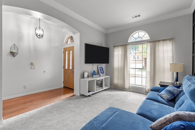 2209 Graystone Ct, Keller, TX 76248 - living area with crown molding, light carpet, a chandelier, arched walkways, and baseboards