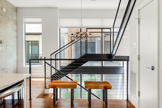 interior space with tile walls, wood finished floors, and plenty of natural light