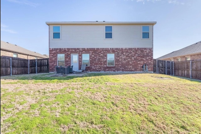 1101 Riverstone Trl, Princeton, TX 75407 - back of property featuring a yard, brick siding, and a fenced backyard