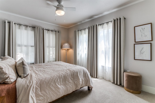 bedroom featuring ceiling fan, baseboards, ornamental molding, and light carpet