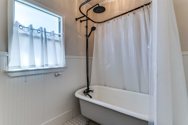bathroom featuring tile patterned flooring and wainscoting