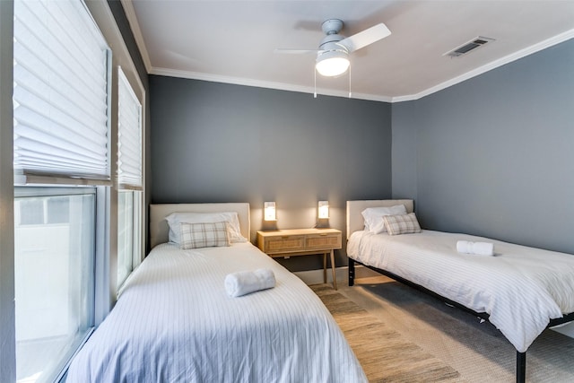 bedroom featuring visible vents, ceiling fan, baseboards, carpet floors, and ornamental molding