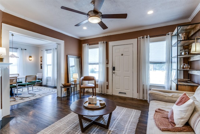 living room featuring recessed lighting, ornamental molding, dark wood-style floors, visible vents, and a ceiling fan