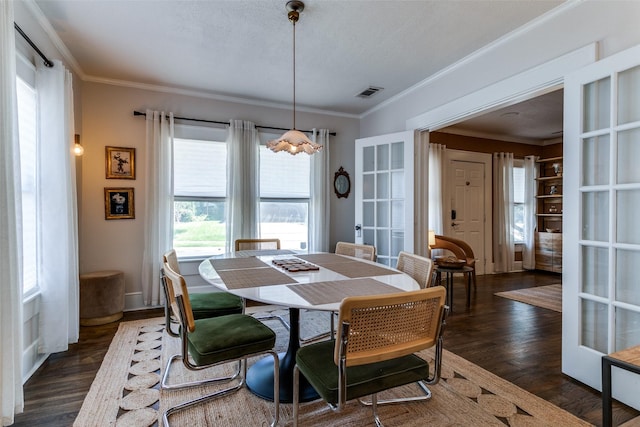 dining room featuring dark wood-style flooring, visible vents, french doors, and ornamental molding