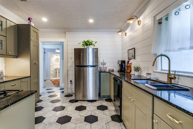 kitchen with dark stone counters, black appliances, a textured ceiling, and a sink