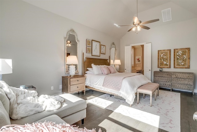 bedroom featuring dark wood finished floors, visible vents, a ceiling fan, and vaulted ceiling