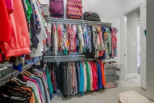 walk in closet featuring carpet flooring