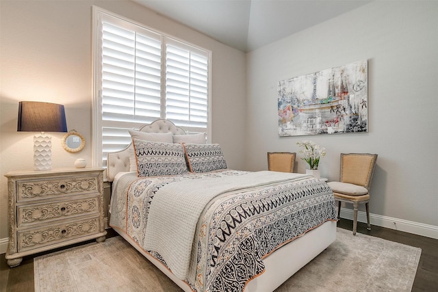 bedroom featuring wood finished floors and baseboards