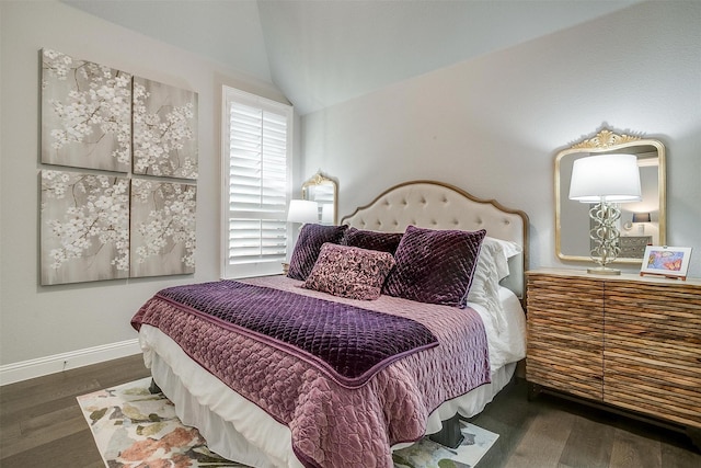 bedroom with baseboards, wood finished floors, and lofted ceiling