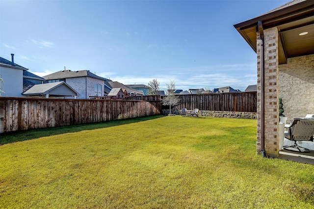 view of yard with a residential view and a fenced backyard