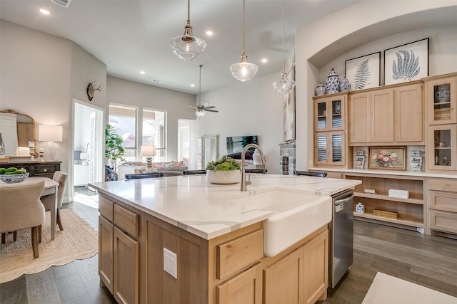kitchen featuring recessed lighting, dishwasher, a sink, and open floor plan