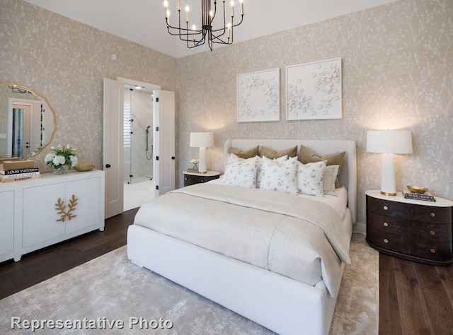 bedroom with a chandelier, wallpapered walls, and wood finished floors