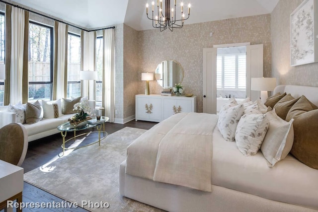 bedroom featuring a chandelier, wallpapered walls, and wood finished floors