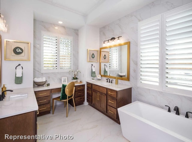 bathroom featuring marble finish floor, a sink, tile walls, and two vanities