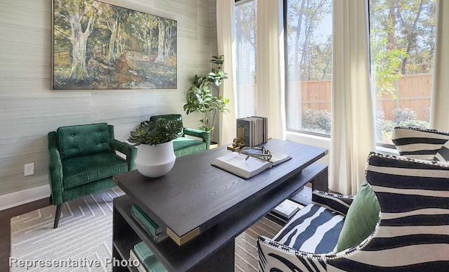 living area with wood finished floors and baseboards