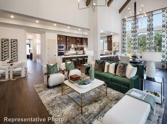 living area with an inviting chandelier, dark wood-type flooring, recessed lighting, and a high ceiling