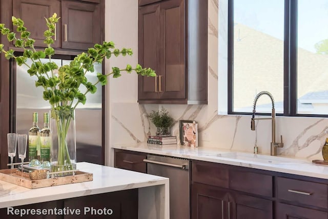 interior space with tasteful backsplash, stainless steel appliances, a wealth of natural light, and a sink