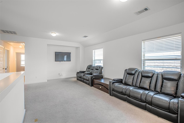 living room with carpet flooring, visible vents, vaulted ceiling, and baseboards