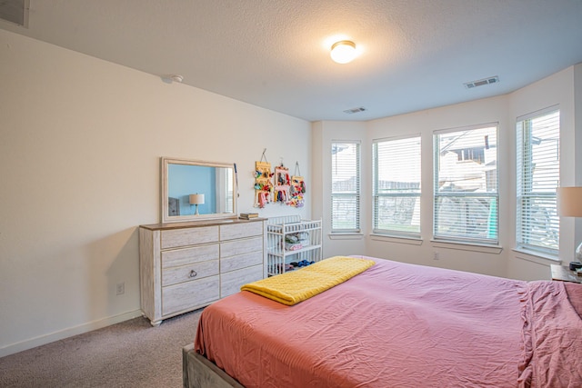 bedroom with visible vents, multiple windows, and carpet flooring