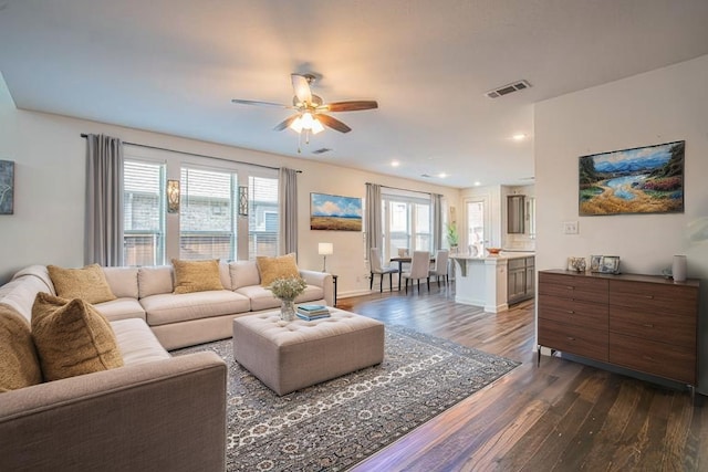 living room with visible vents, baseboards, dark wood-style flooring, recessed lighting, and a ceiling fan