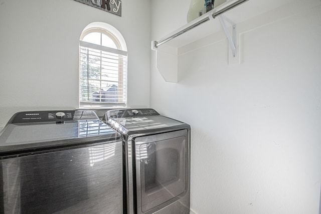 clothes washing area featuring washer and clothes dryer and laundry area